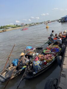 Boats selling fruits at sunrise in Cai Rang Floating Market, Can Tho, Vietnam.