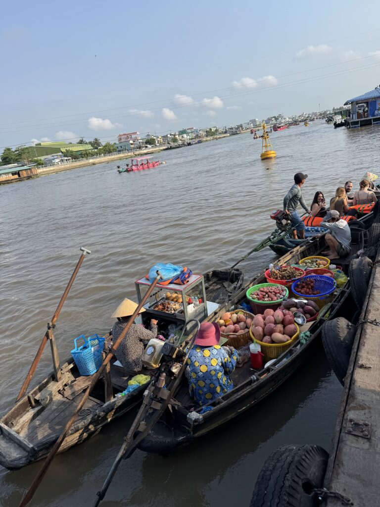 Boats selling fruits at sunrise in Cai Rang Floating Market, Can Tho, Vietnam.