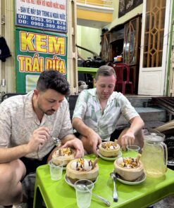 Saigon street food vendor serving local dishes at night